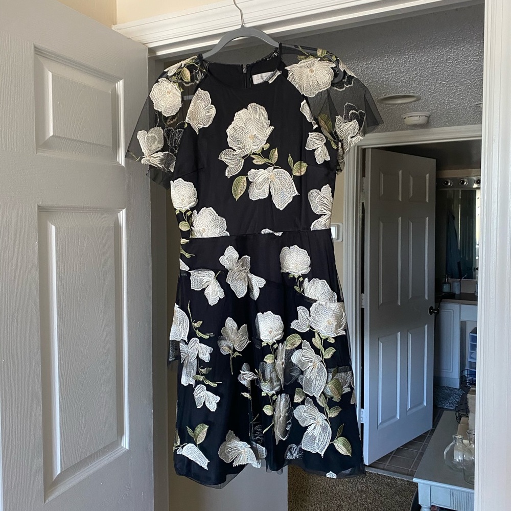 Black Cocktail Dress with White Flower Detail